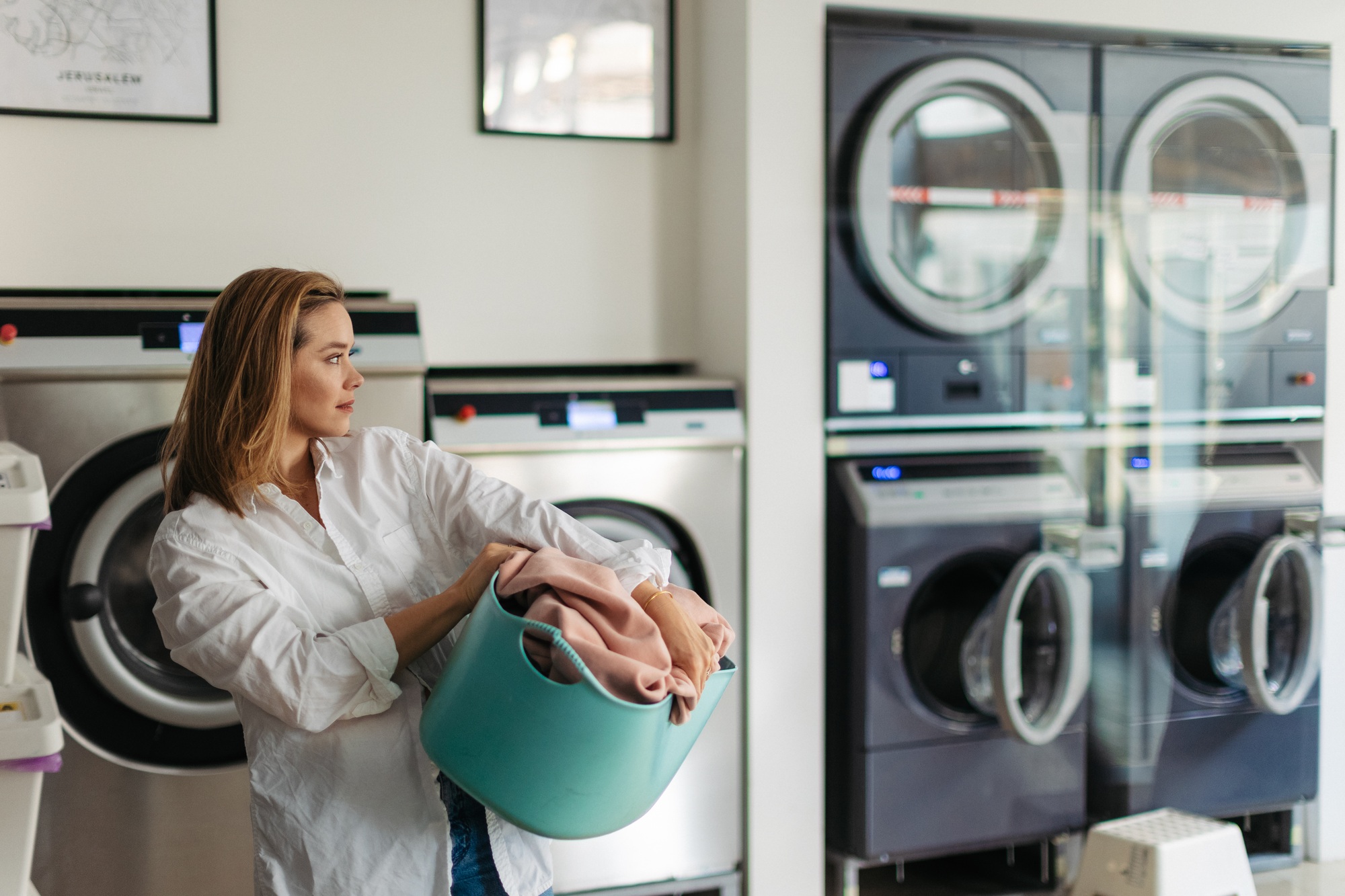 Young woman waiting in a laundry room.